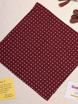 Maroon fabric with white pattern on a light surface