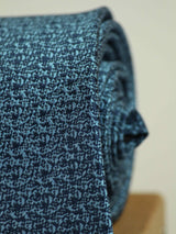 Blue abstract necktie in woven microfiber, tied view
