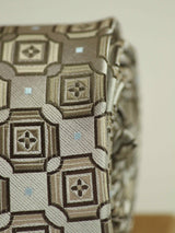 Grey geometric necktie in woven microfiber, tied view