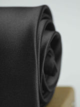 Grey solid necktie in woven microfiber, tied view