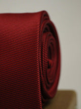 Maroon solid necktie in woven microfiber, tied view