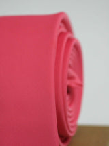 Pink solid necktie in woven microfiber, tied view