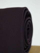 Purple solid necktie in woven microfiber, tied view