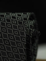 Black geometric necktie in woven microfiber, tied view