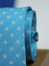 Blue geometric necktie in woven microfiber, tied view