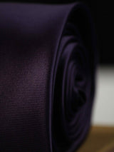 Purple solid necktie in woven microfiber, tied view