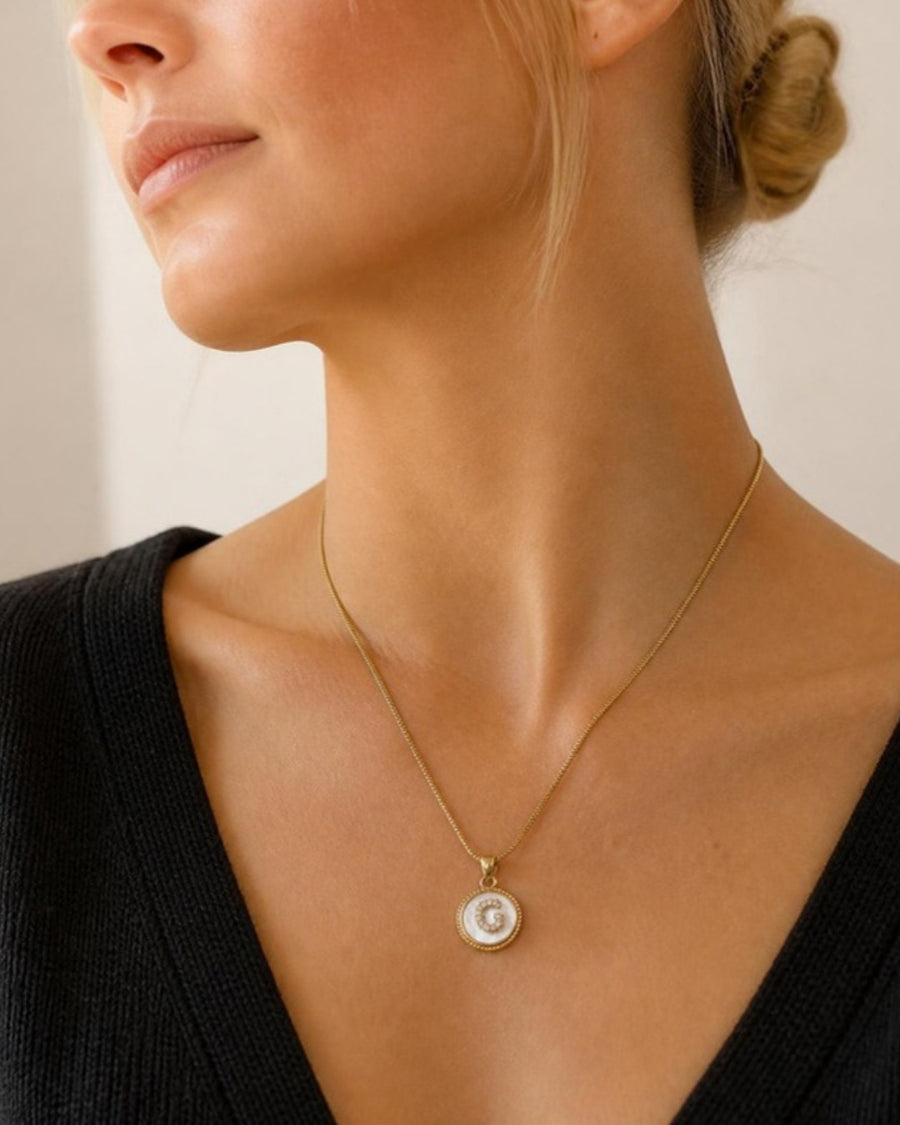 Gold initial pendant necklace worn on model - Tossido jewellery