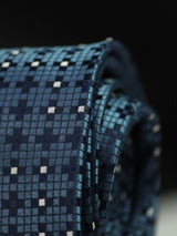 Blue geometric necktie in woven microfiber, tied view